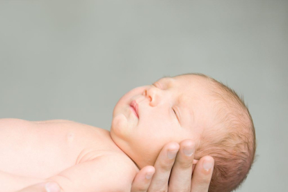 Portrait of a sleeping newborn hold at hands. Family, healthy birth concept